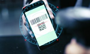 QR code on phone screen signifies cashless casino options at Rolling Hills Casino in Corning