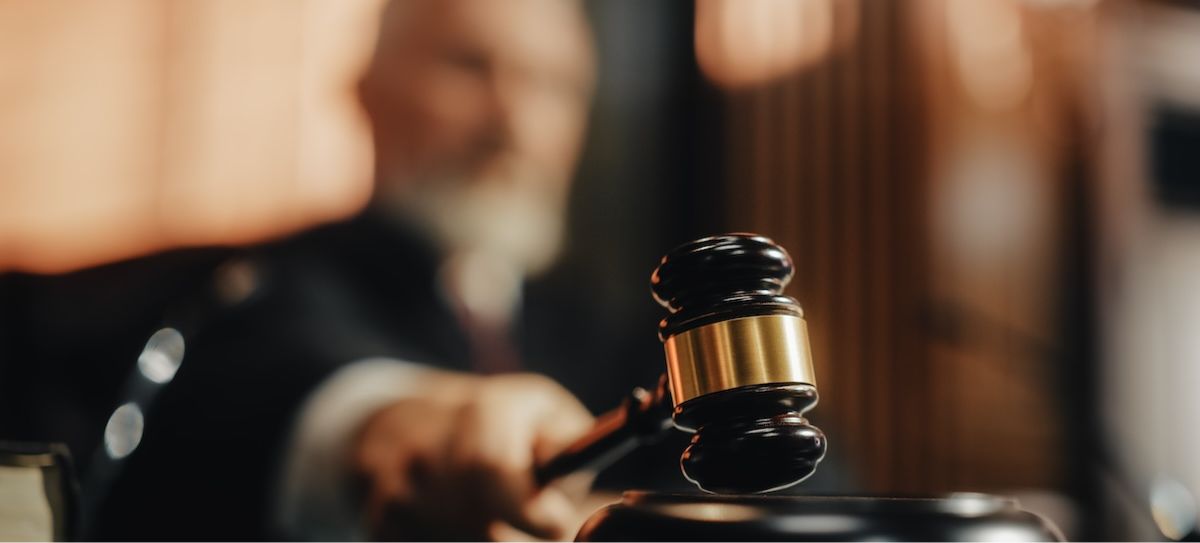 Judge pounds a gavel in a courthouse. With SB 549's passage, California tribes can file one collective lawsuit challenging cardrooms' ability to offer certain games of chance.