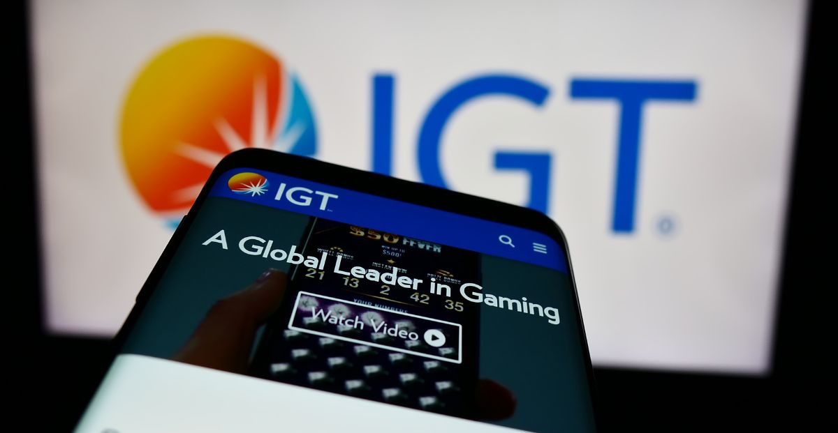 a mobile phone on the IGT website in front of an IGT logo